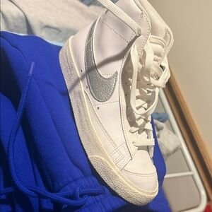 Nike Women’s White High-Top Sneakers with Metallic Silver Swoosh